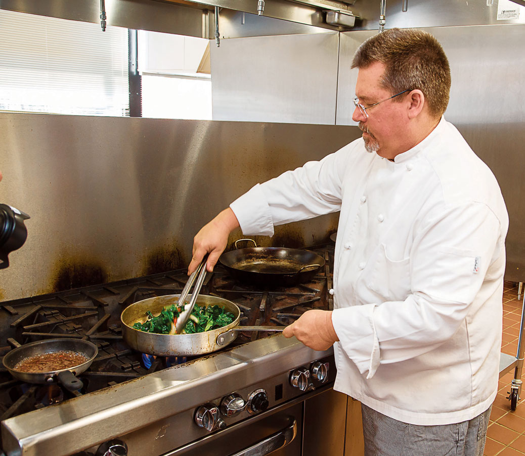 Chef Bob Perry prepares a dish of Ubatuba Paprika Chicken topped with Buttermilk Crème Fresh