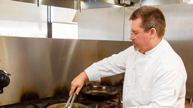 Chef Bob Perry prepares a dish of Ubatuba Paprika Chicken topped with Buttermilk Crème Fresh